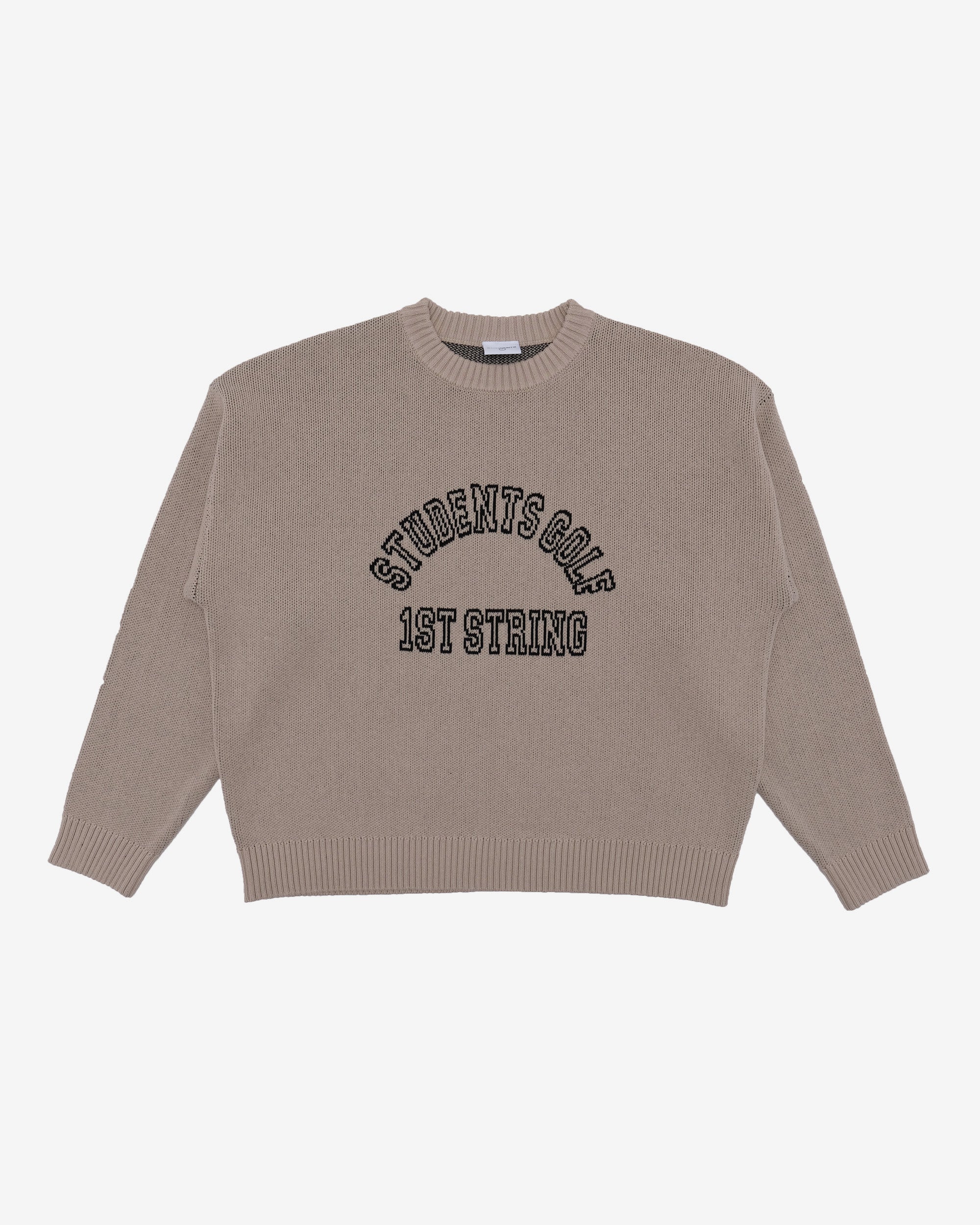 Beige sweater with text on a light gray background