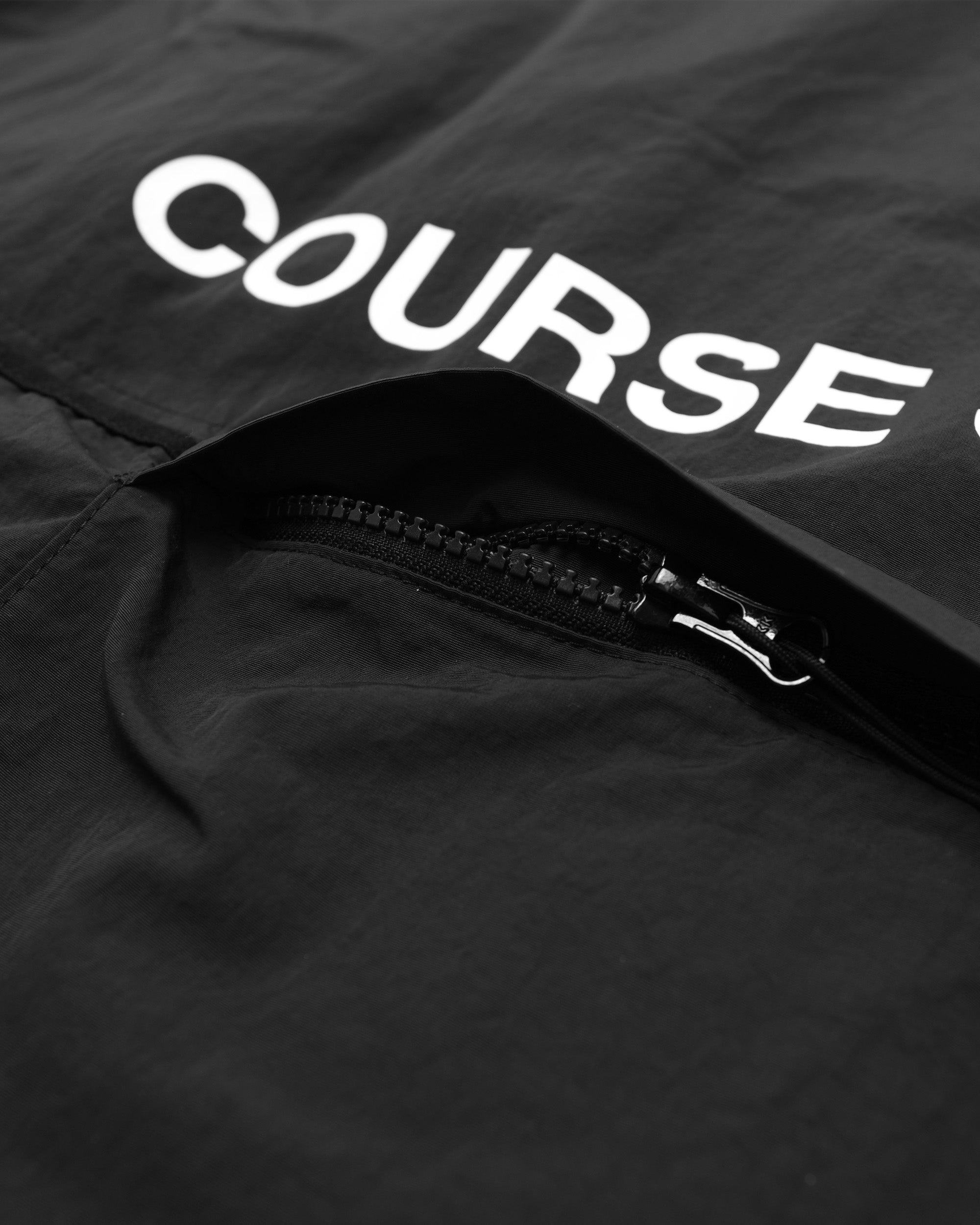 Black jacket with 'COURSE' logo on a dark background