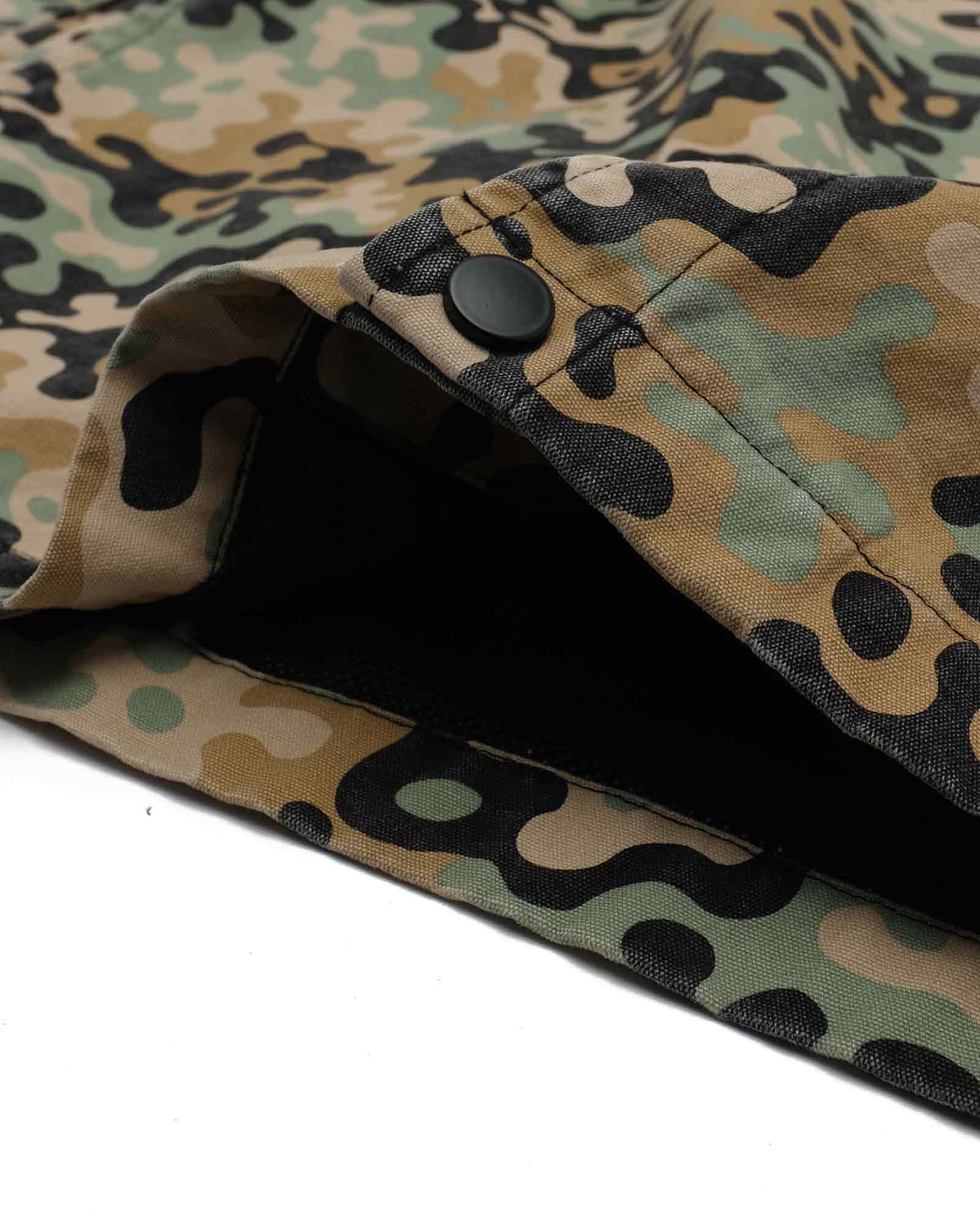 Close-up of a camouflage-patterned fabric with a black interior