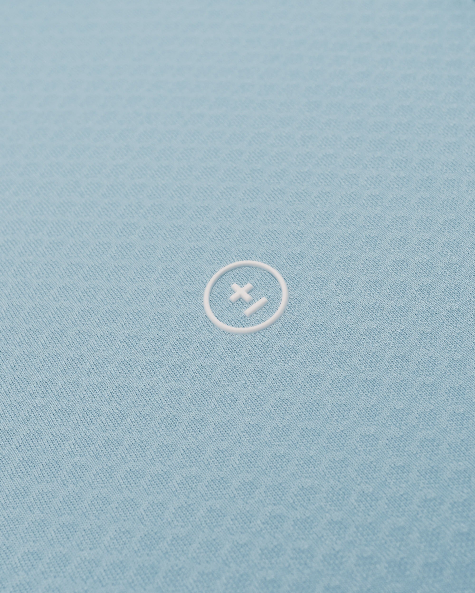 Light blue fabric with a white logo in the center
