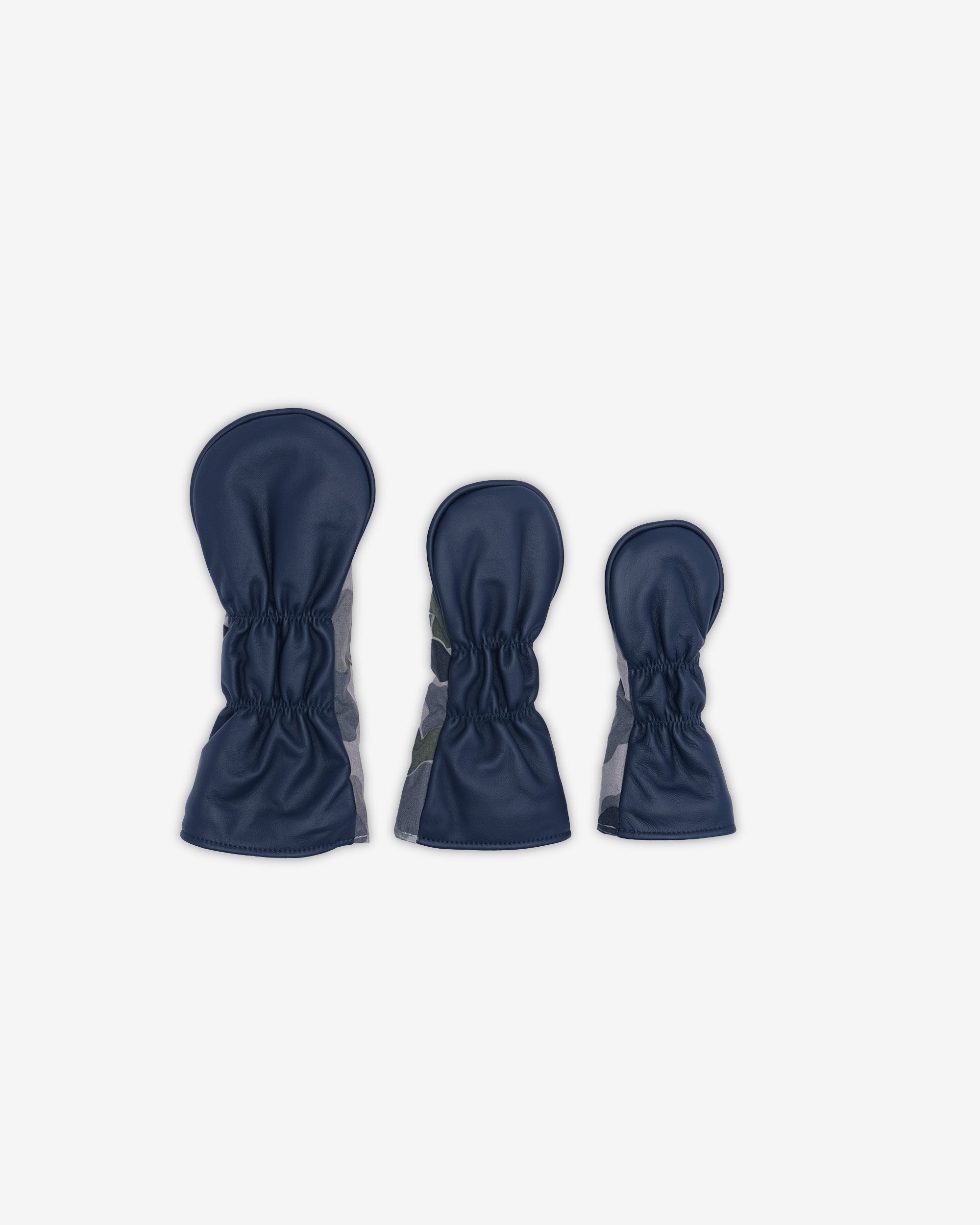 Three pairs of navy head covers on a white background