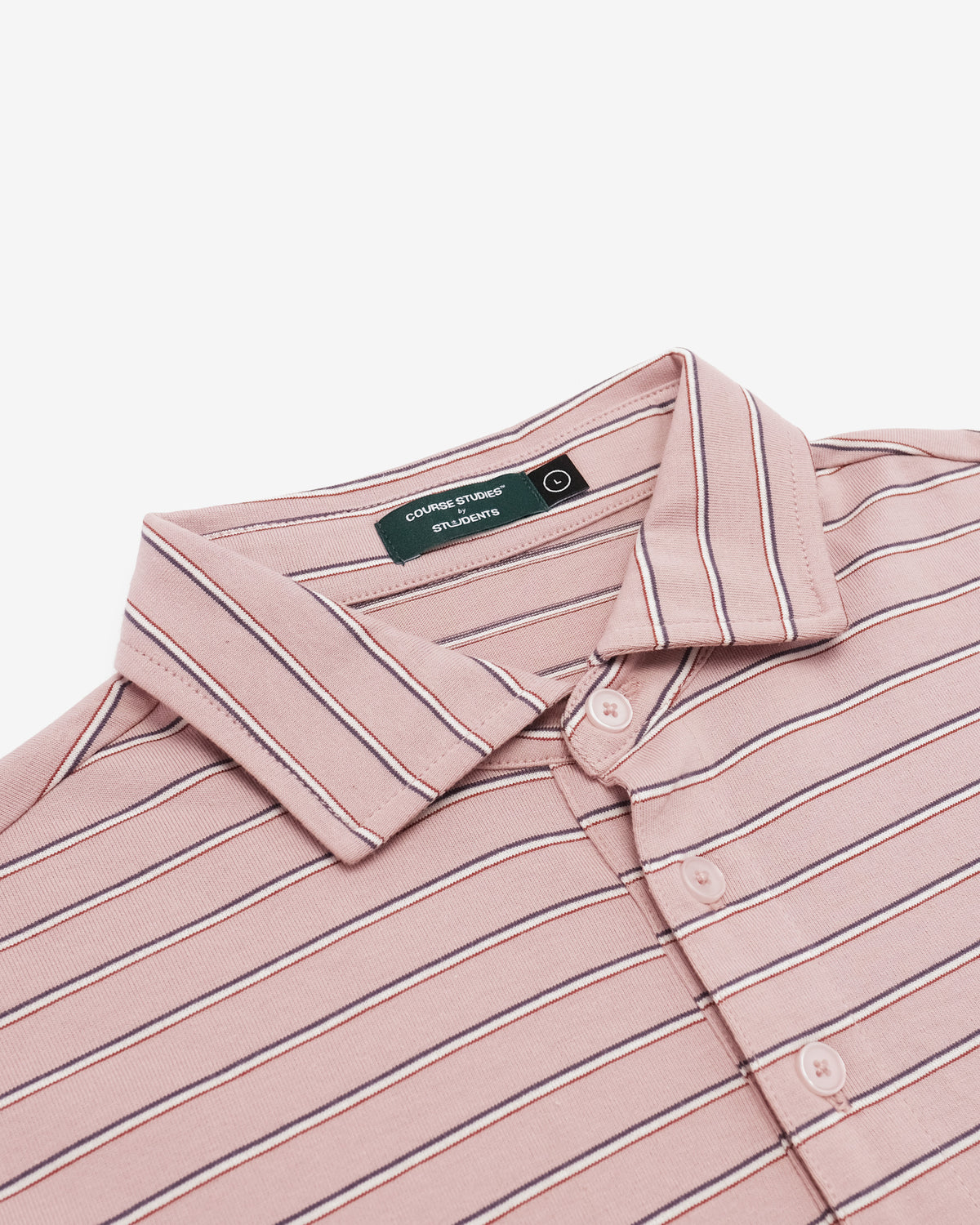 A close-up of a pink button-up shirt with thin navy and white stripes, featuring a pointed collar and a visible neck label for 'Cottonwood Creek Blanks'.