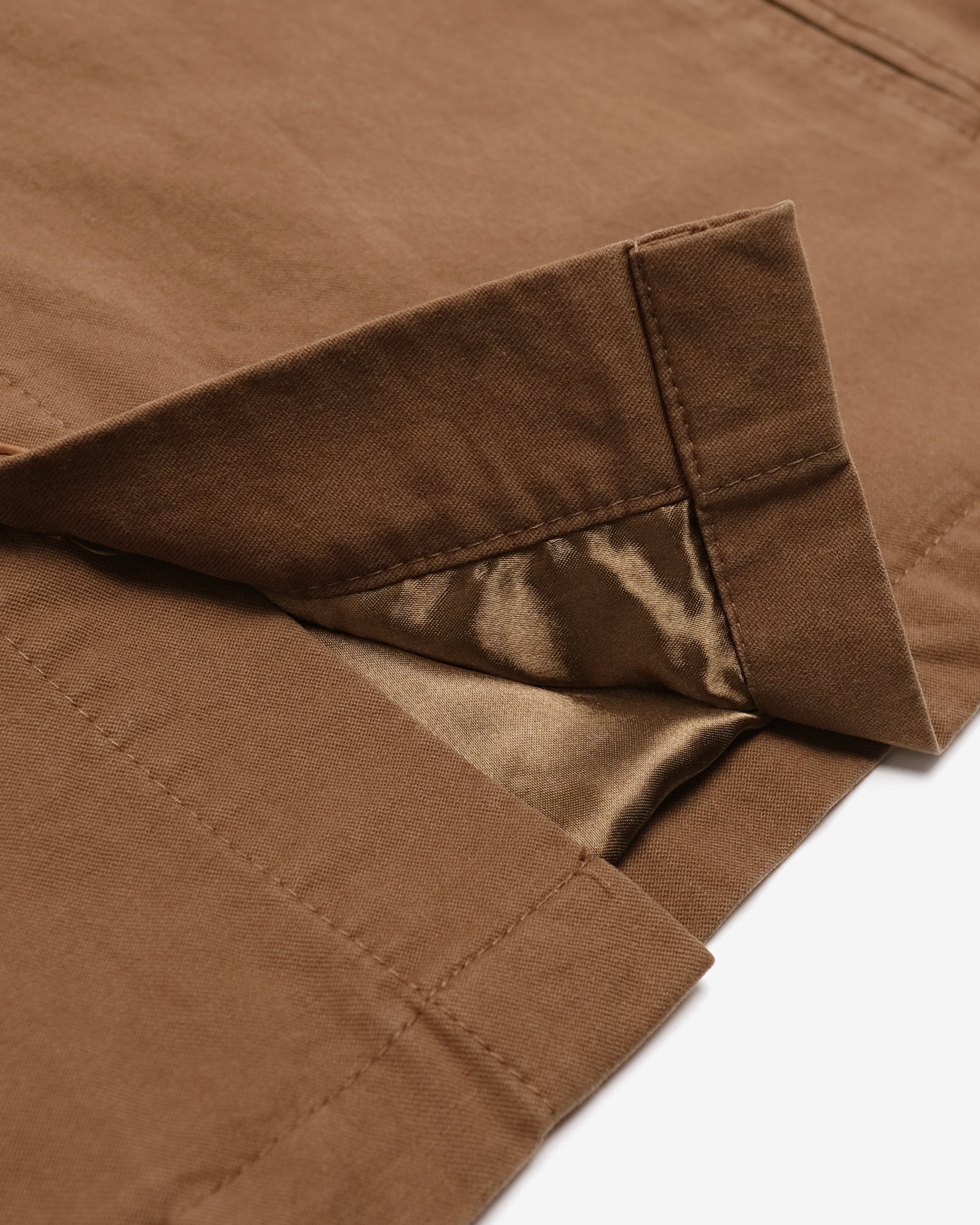 Close-up of brown fabric with a white background