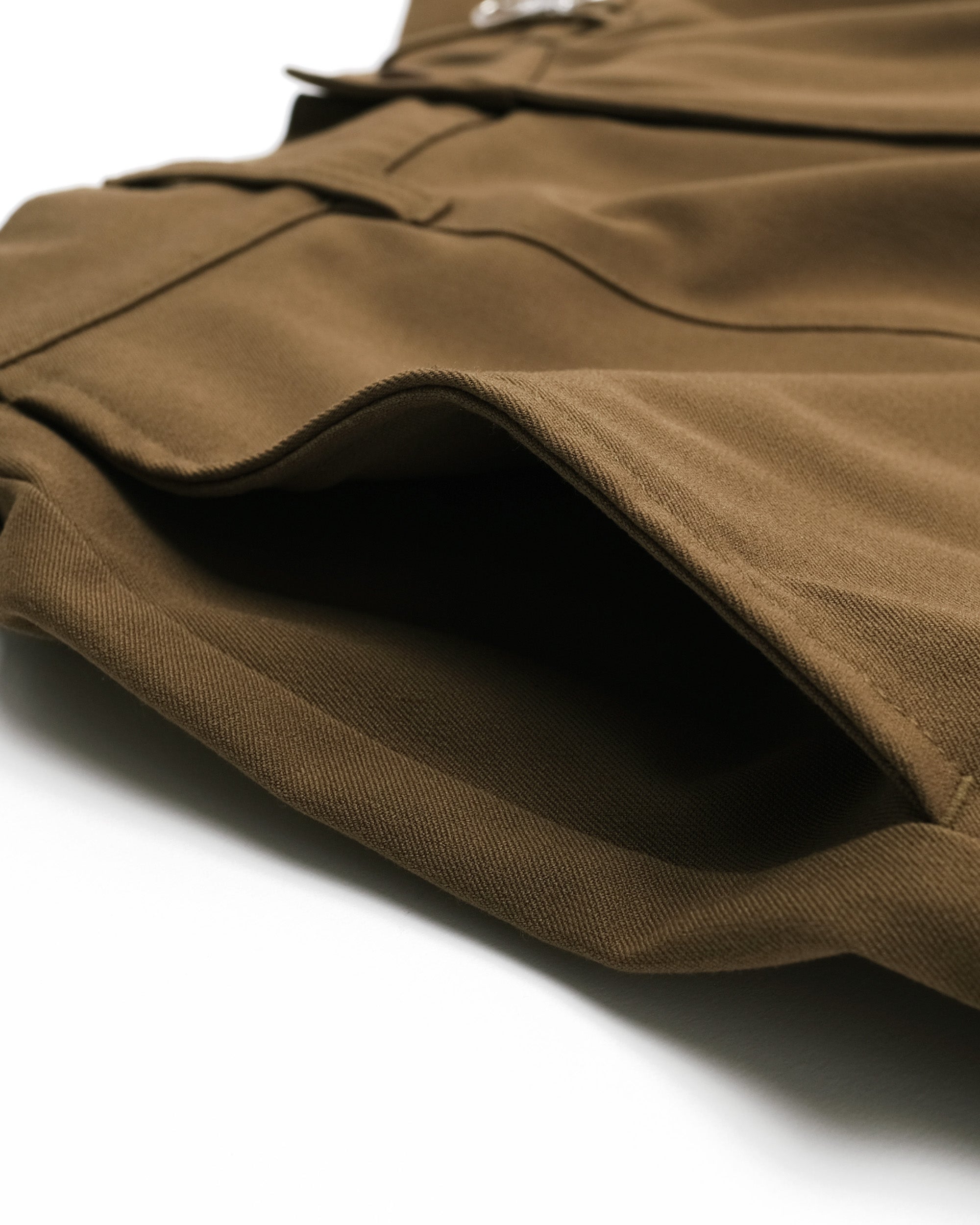 Close-up of brown fabric with a pocket on a white background