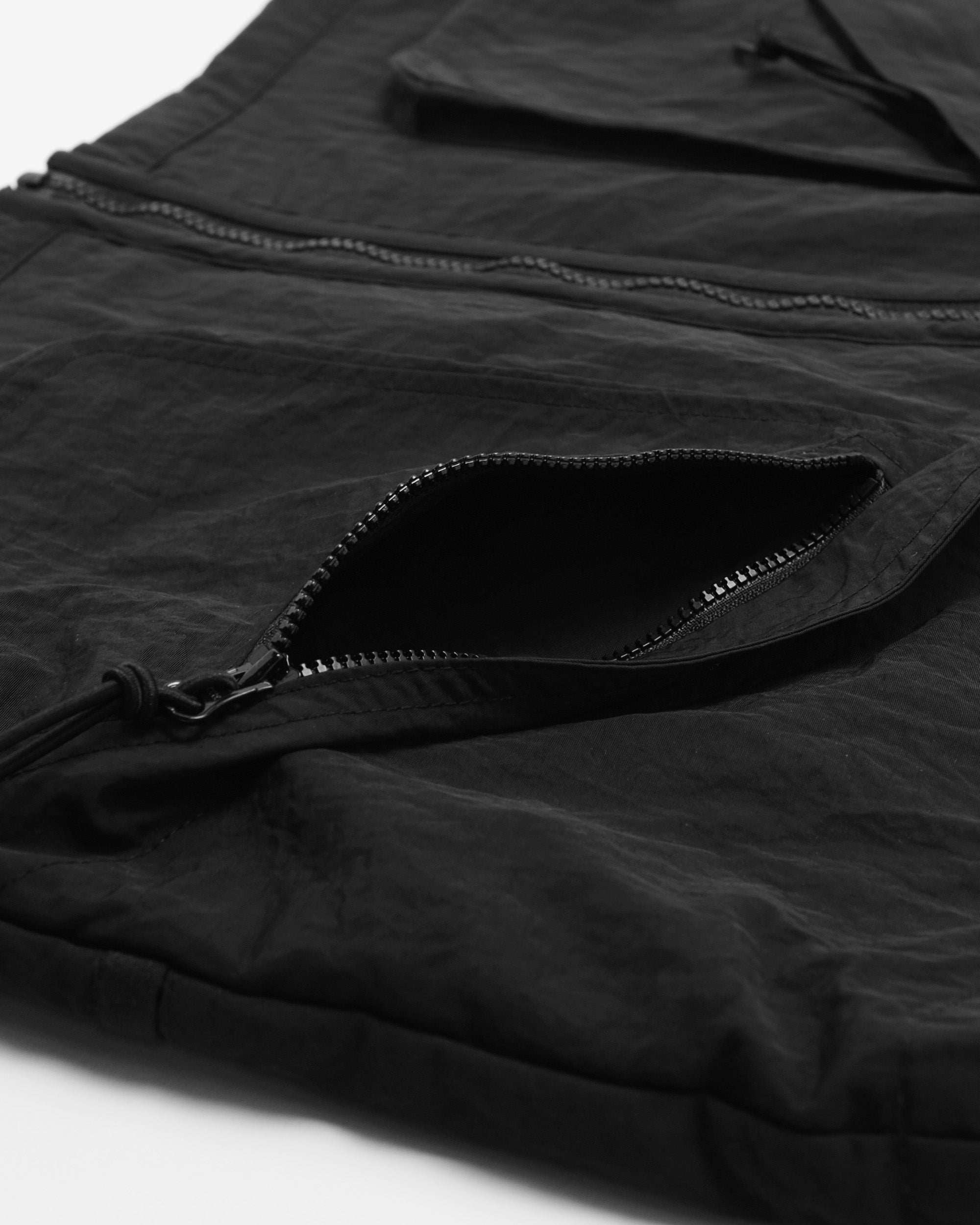 Close-up of a black jacket with zippers on a white background