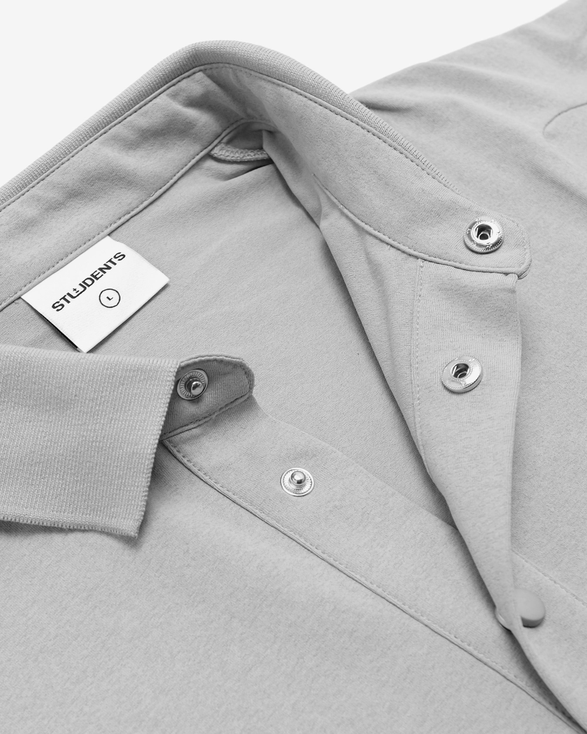 Gray shirt with a brand label on a white background